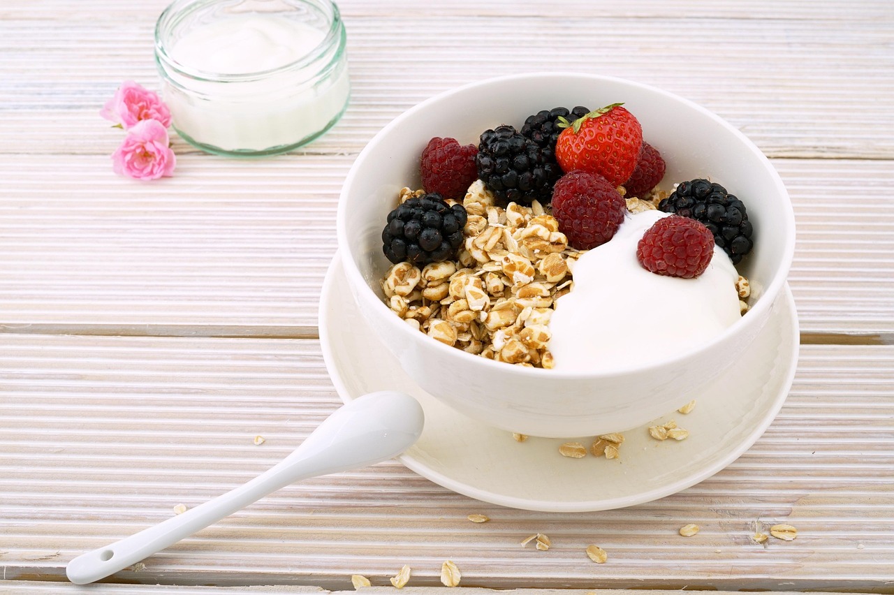 Tigela com granola, frutas vermelhas frescas e iogurte, usados para montar a cobertura